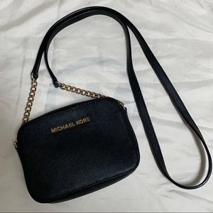 Small black Michael Kors purse with gold hardware in excellent condition